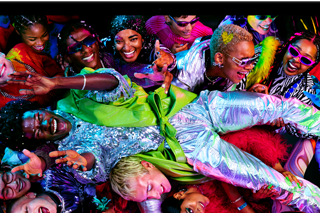 Colourful screen on a MacBook Pro of a person crowdsurfing at a party, showcasing the vibrant Liquid Retina XDR display