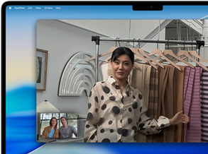 A video call on a MacBook Pro where a woman shows fabrics to two people on the call, with Centre Stage keeping her centred in the frame as she moves around