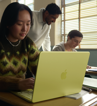 A student uses MacBook Neo, citrus colour, unplugged in a classroom setting